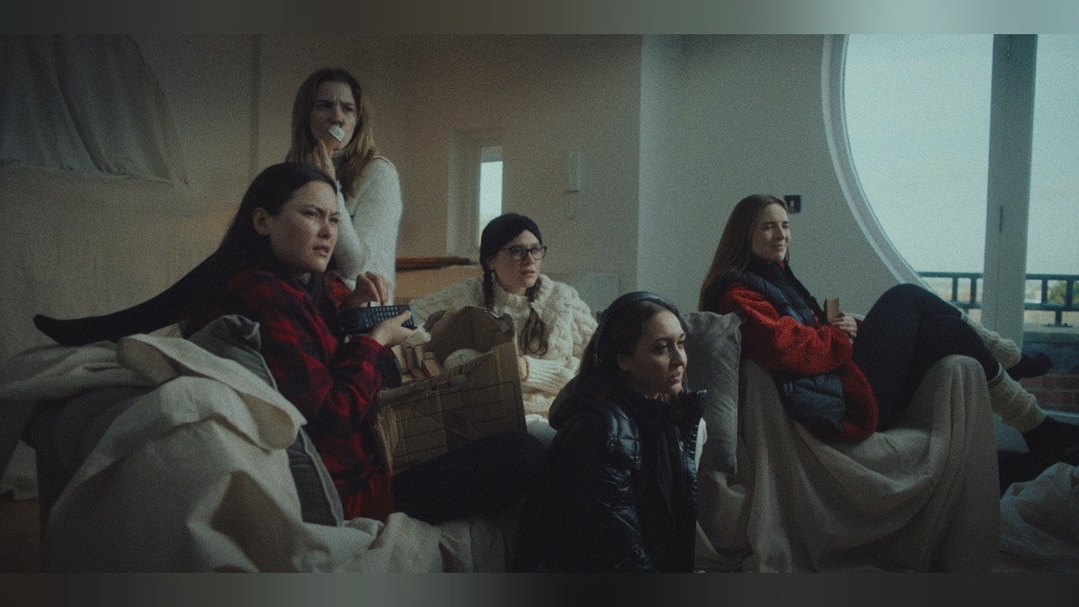 Scare Package II (2022) - A group of young women watching a tv offscreen