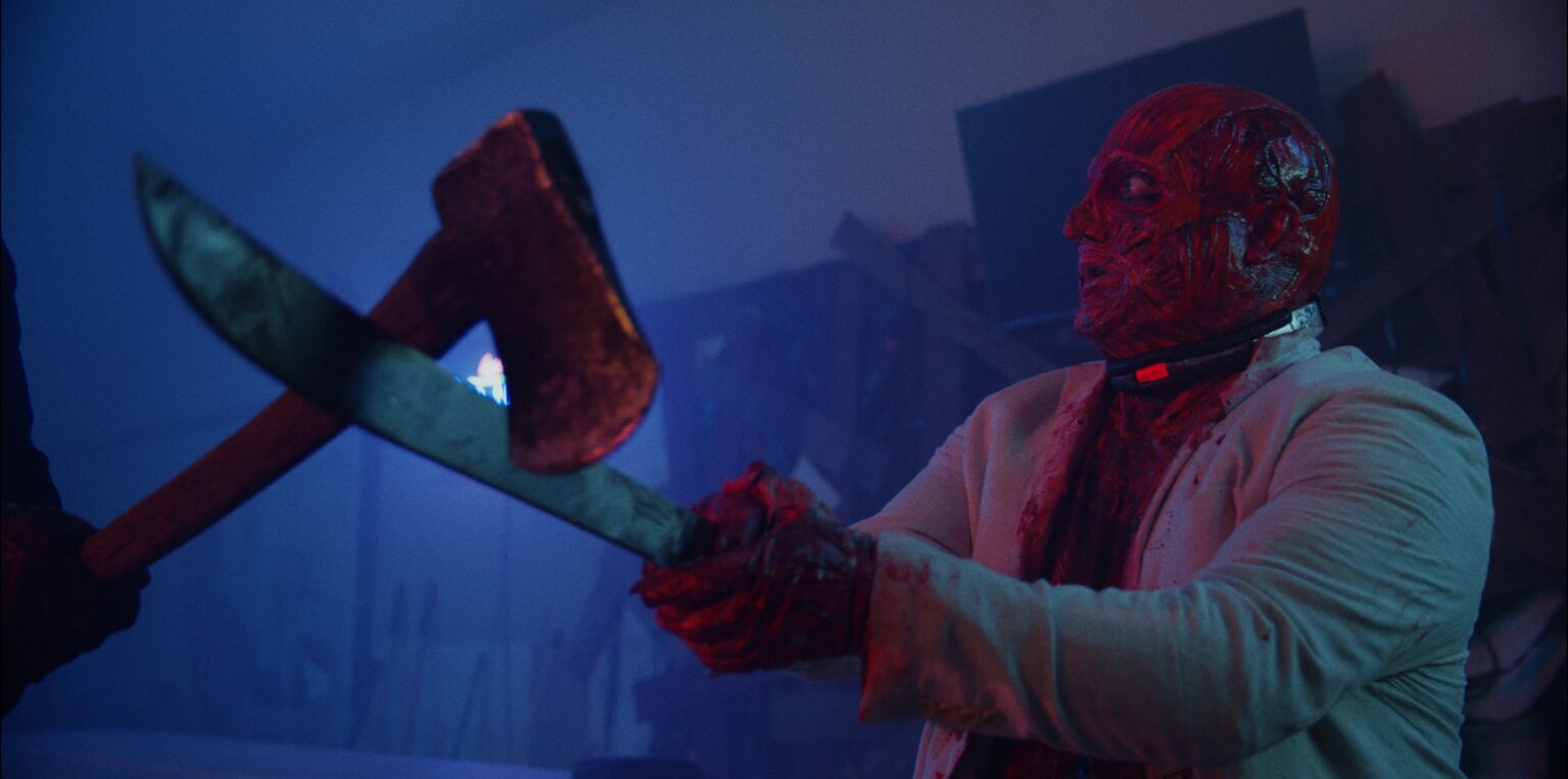 Scare Package II (2022) - A skinned man in a white suit blocking an axe with a machete