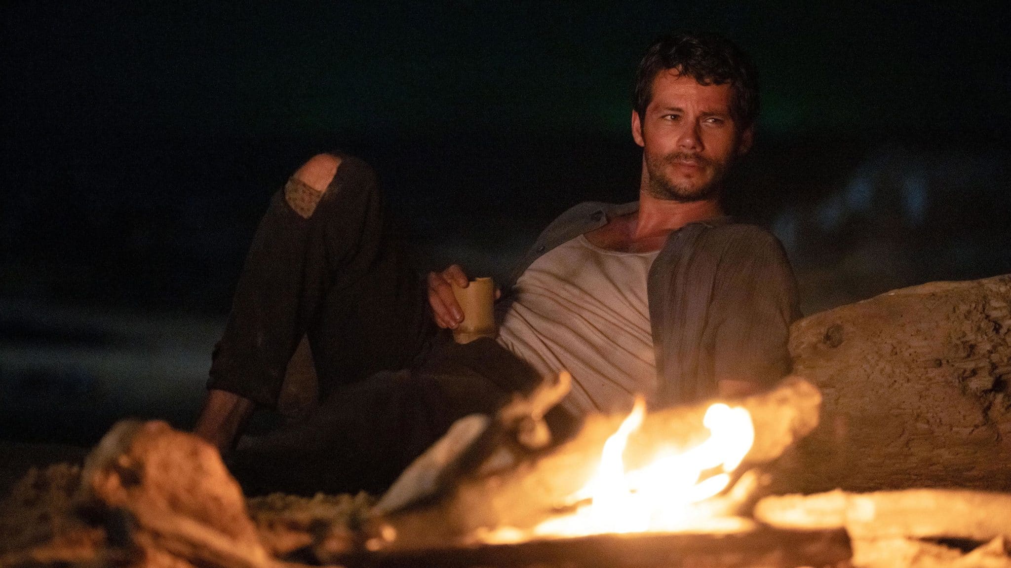 Bradley sits by the fire.