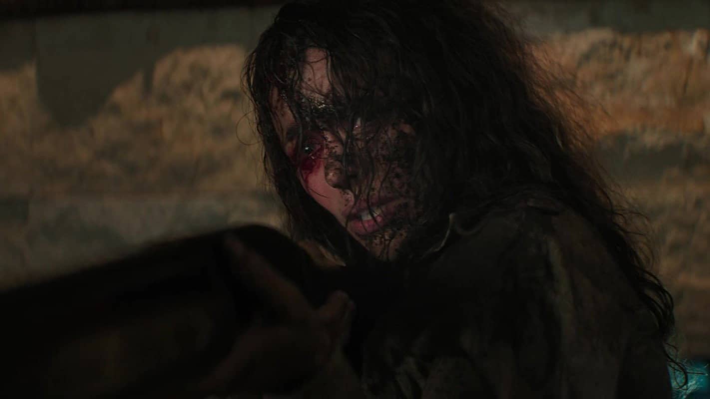 Linda's face is caked with dirt and her eye is bloody from being gauged.