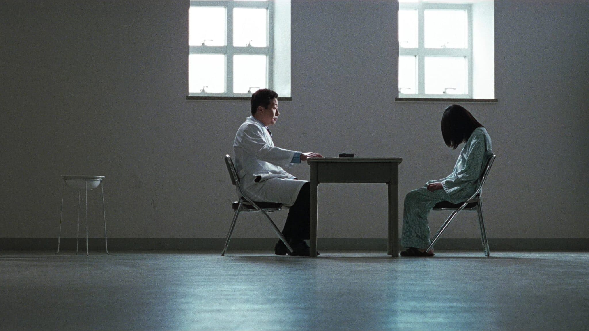 #31DaysofHalloween - A Tale of Two Sisters (2003) - A Young woman sits across the table from a doctor.